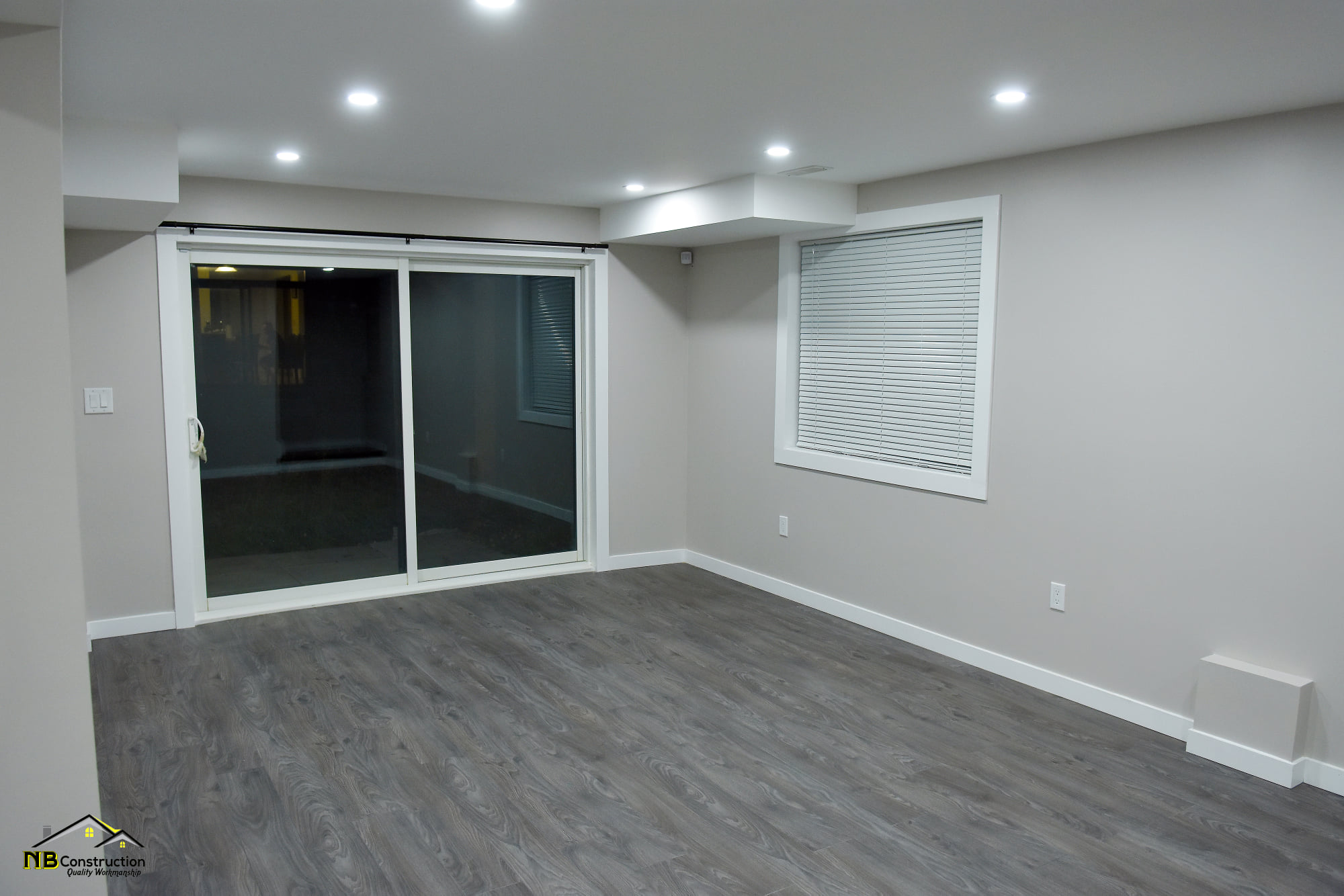 Finished basement with new flooring and lighting